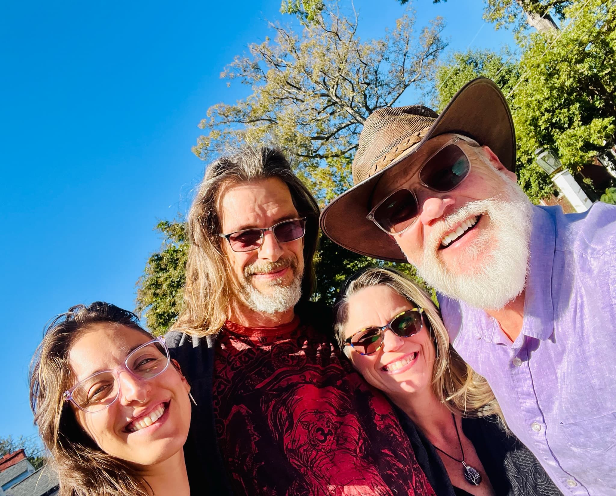 Selfie of four people outdoors
