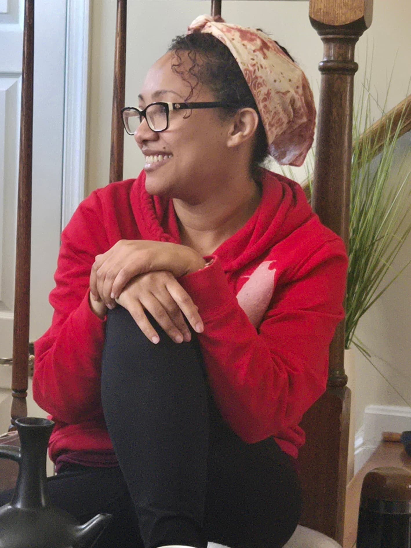 Woman smiling in red hoodie
