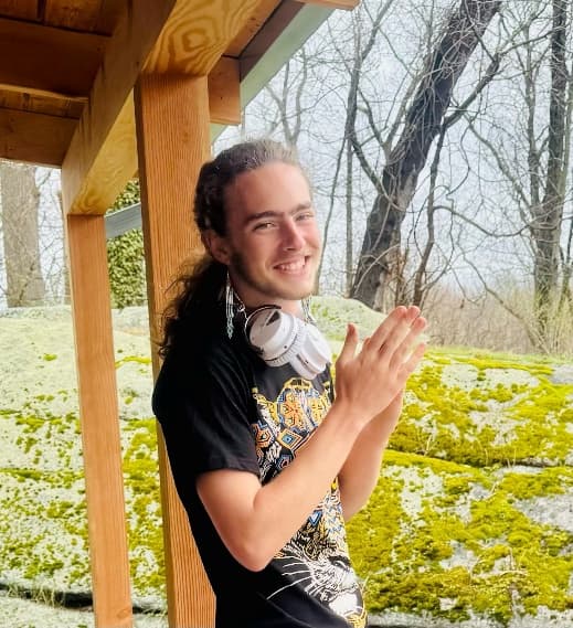 Young man clapping on porch
