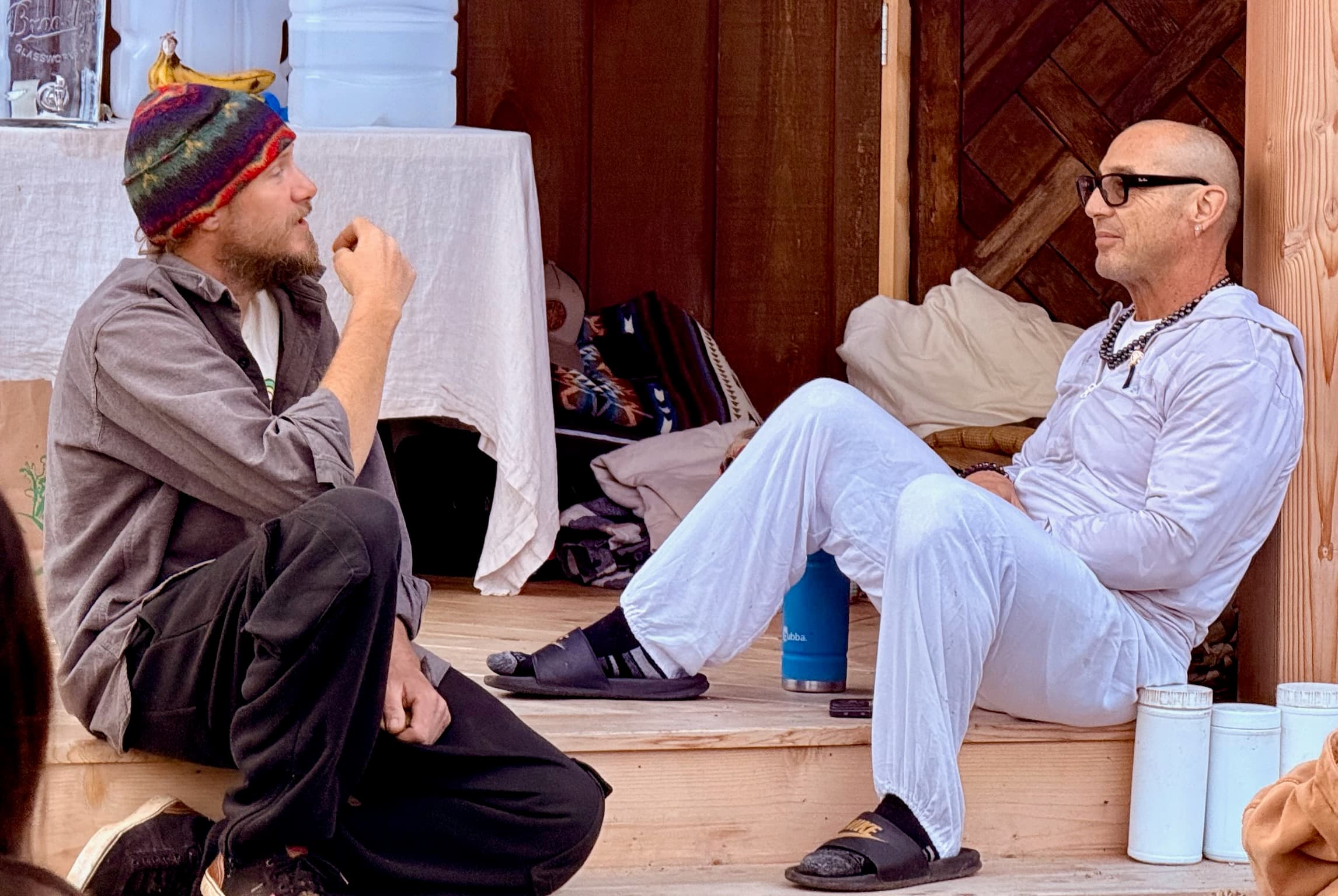 Two men chatting on porch